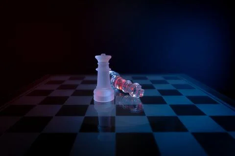 Dramatic glass chess set with red and blue lighting symbolizing strategy, abuse  Stock-Fotos