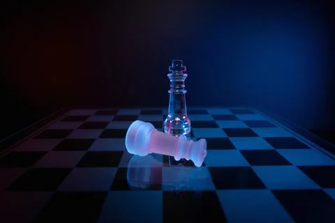 Dramatic glass chess set with red and blue lighting symbolizing strategy, abuse  Stock-Fotos