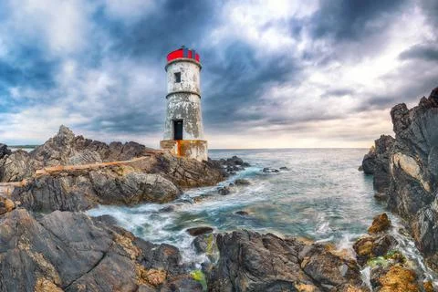 Dramatic gloomy view of Capo Ferro Lighthouse. Stock Photos