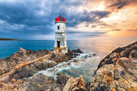 Dramatic gloomy view of Capo Ferro Lighthouse. Stock Photos