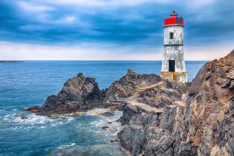 Dramatic gloomy view of Capo Ferro Lighthouse. Stock Photos
