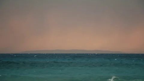 Dramatic Glow Stormy Ocean Waves Island on Horizon 2 Video stock 80199181