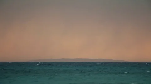 Dramatic Glow Stormy Ocean Waves Island on Horizon 4 Video stock 80199893