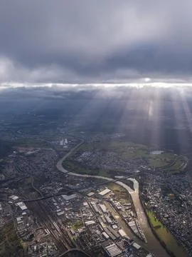 Dramatic God Rays Over Industrial River City Stock Photos