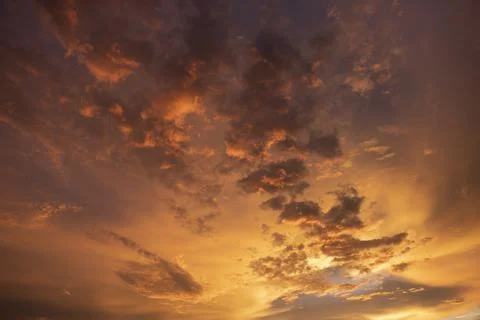 Dramatic golden clouds in sunset sky Stock Photos
