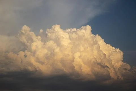 Dramatic golden cumulus cloud formation 写真素材