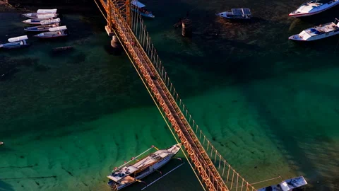 Dramatic Golden Hour Drone Shot of Yellow Bridge Bali Indonesia 4K Video stock 335116315