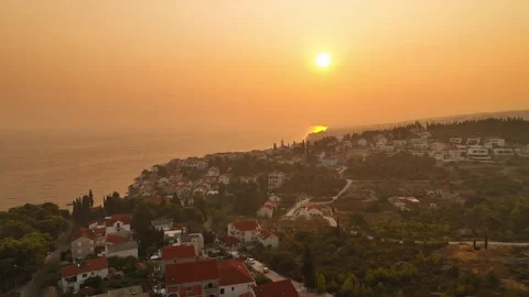 Dramatic golden hour sunrise shot showing sun ray refraction through heavy Stock Footage 346016293