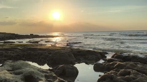 Dramatic Golden Hour Sunset on Rocky Beach Shoreline Video stock 341504664