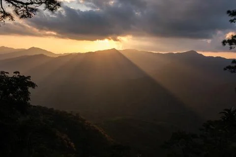 Dramatic Golden Sun Rays Illuminating Mountain Ridges At Sunset In Chiang R.. Stock Photos