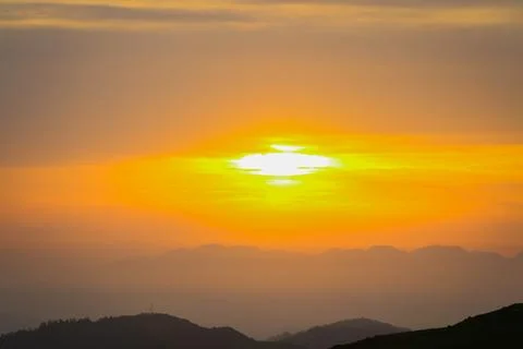 Dramatic Golden Sunset Behind Mountain Peaks Stock Photos