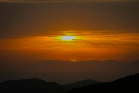 Dramatic Golden Sunset Behind Mountain Peaks Stock Photos