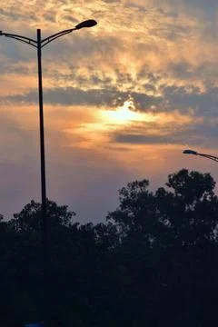 Dramatic golden sunset behind textured clouds Stock Photos