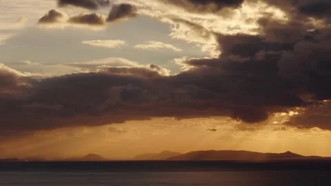 Dramatic golden sunset clouds moving over the sea and islands Stock Footage 347635115