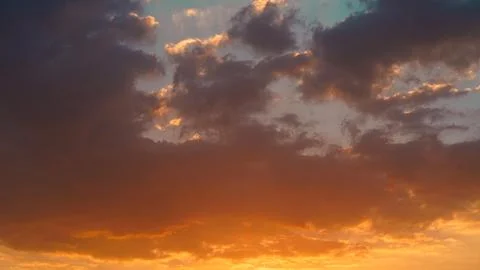 Dramatic Golden Sunset Clouds with Sun Rays in Sky Stock Photos