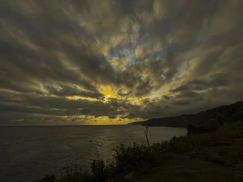 Dramatic Golden Sunset Over Cloudy Horizon Above Calm Sea Stock Photos