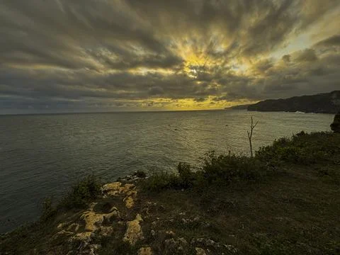 Dramatic Golden Sunset Over Cloudy Horizon Above Calm Sea Stock Photos