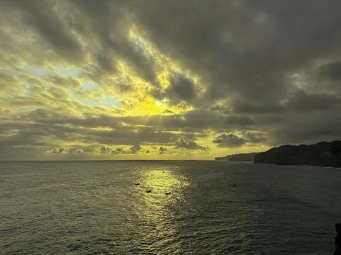 Dramatic Golden Sunset Over Cloudy Horizon Above Calm Sea Stock Photos