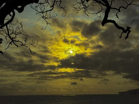 Dramatic Golden Sunset Over Cloudy Horizon Above Calm Sea Stock Photos