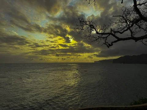 Dramatic Golden Sunset Over Cloudy Horizon Above Calm Sea Stock Photos