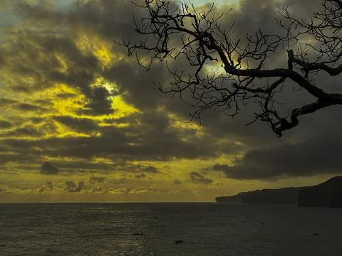 Dramatic Golden Sunset Over Cloudy Horizon Above Calm Sea Stock Photos