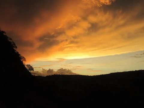 Dramatic Golden Sunset Over Mountain Landscape Stock Photos