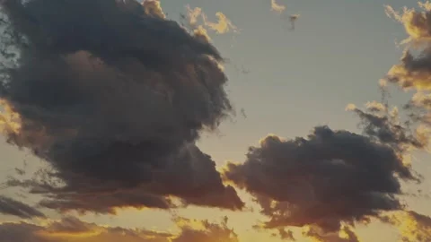 Dramatic golden sunset sky with dark clouds moving Stock Footage 324875488