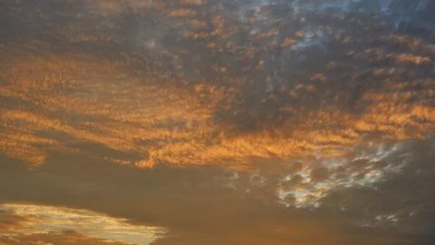Dramatic golden sunset sky with textured clouds Stock Photos