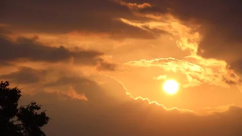 Dramatic Golden Sunset Through Dark Moving Clouds Time-Lapse Stock-Footage 319630650