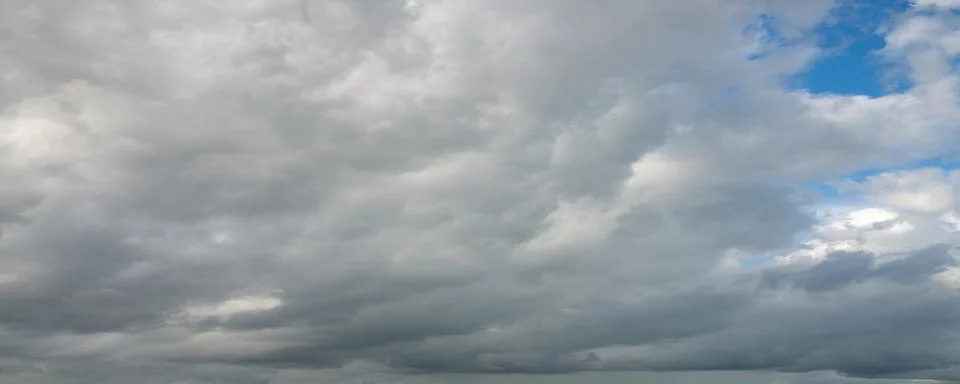 Dramatic Gray Storm Clouds with Blue Sky Stock Photos