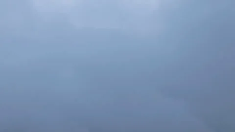 Dramatic Gray Storm Clouds Moving Across Overcast Sky with Sun Rays Breaking. Stock Footage 338360419