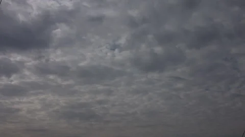 Dramatic gray stratocumulus clouds moving across the sky Stockbeeldmateriaal 342237252