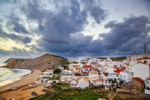 Dramatic grey cloud formation swirling above the traditional fishing village of 写真素材