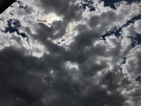 Dramatic grey skyline with bright sun Stock Photos