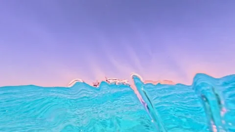 Dramatic half underwater wave rolling over camera with distant yachts on Stock Footage 324554385