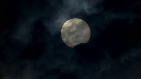 Dramatic hdr sun eclipse by moon at cloudy sky, real 4k video of solar eclipse Stock Footage 145923999