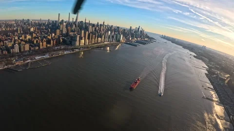 Dramatic Helicopter views of Manhattan Skyline With Boats on the Water Stock Footage 319356372