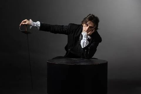 A dramatic hero with a sword in his hands experiences sadness and melancholy, Stock Photos