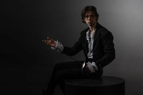 A dramatic hero with a sword in his hands experiences sadness and melancholy, Foto stock