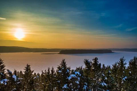 Dramatic High Contrast Clouds in Sunset Over Frozen Lake Stock Photos