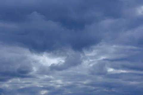 Dramatic high deep blue sky with fluffy clouds, cloudscape in stormy weather Stock Photos