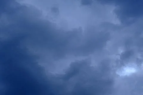 Dramatic high deep blue sky with fluffy clouds, cloudscape in stormy weather Stock Photos