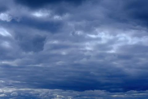 Dramatic high deep blue sky with fluffy clouds, cloudscape in stormy weather Stock Photos