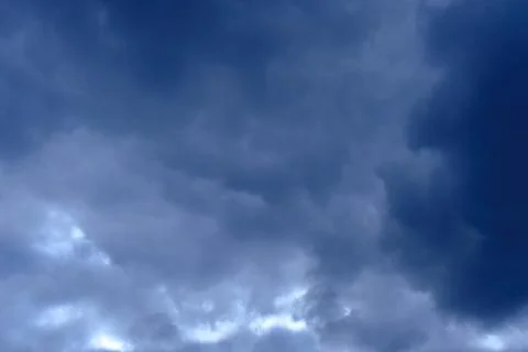Dramatic high deep blue sky with fluffy clouds, cloudscape in stormy weather Photos