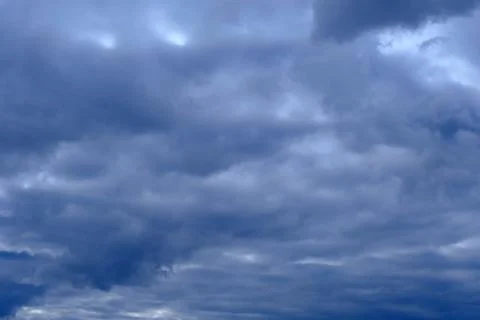Dramatic high deep blue sky with fluffy clouds, cloudscape in stormy weather Stock Photos
