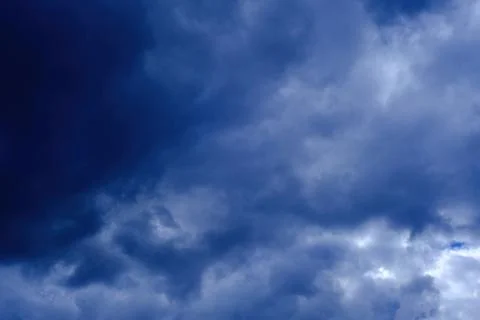Dramatic high deep blue sky with fluffy clouds, cloudscape in stormy weather Stock Photos