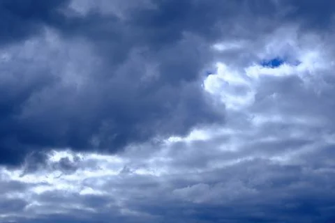 Dramatic high deep blue sky with fluffy clouds, cloudscape in stormy weather Stock Photos