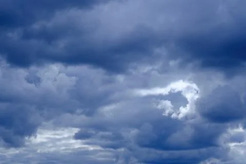 Dramatic high deep blue sky with fluffy clouds, cloudscape in stormy weather Photos