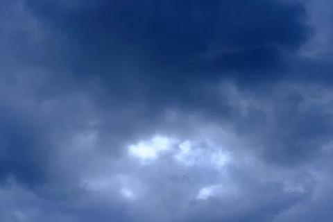 Dramatic high deep blue sky with fluffy clouds, cloudscape in stormy weather Stock Photos