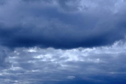 Dramatic high deep blue sky with fluffy clouds, cloudscape in stormy weather Stock Photos
